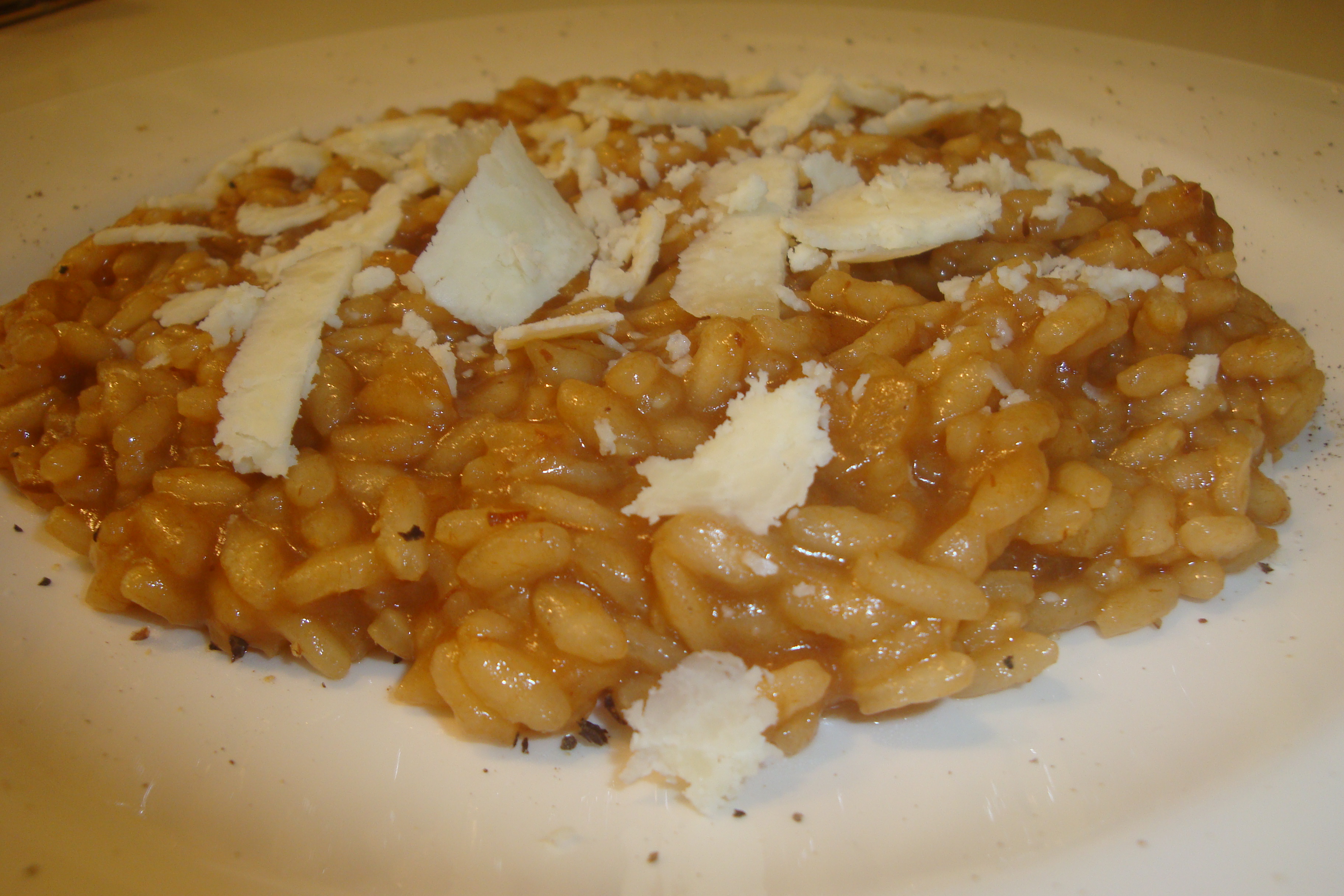 RISOTTO WITH GRAVY OF ROAST MEET WITH SHALLOTS OF ROMAGNA PGI AND SCALES OF CASTELMAGNO PDO